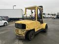 A yellow 2000 Hyster 120 forklift with a propane tank mounted on the back and large rubber tires