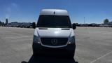 A 2016 Mercedes-Benz Sprinter van with a silver exterior and a black front bumper facing directly towards the viewer