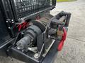 Close-up of a 2023 Prinoth Panther T6 winch showing the drum and cable mechanism along with red hooks and mounting components