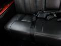 Interior view of a 2008 Cadillac Limousine featuring black leather seating with seatbelts