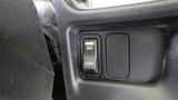 Close-up of a dashboard switch panel featuring an ECON button with a green indicator light and an ON button beside it