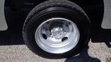 A close-up of a silver wheel with a black tire designed for a 2005 Morgan Olson Workhorse vehicle