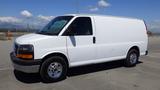 A white 2012 GMC Savana van with a sleek body design and chrome wheels parked on a flat surface