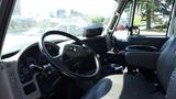 Interior view of a 2013 International 7400 Workstar truck showing the driver's seat steering wheel and dashboard with various gauges and controls