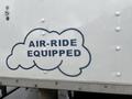 A label on the side of a truck featuring the text AIR-RIDE EQUIPPED in bold letters within a cloud-like graphic