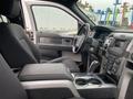 Interior view of a 2014 Ford F-150 showing the driver's seat center console gear shift and dashboard controls