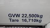 A close-up of a white truck with the text GVW 22,500kg and Tare 16,710kg displayed prominently on its side