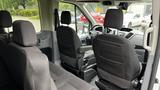 Interior view of a 2017 Ford Transit showing the front seats and dashboard with modern controls and a spacious layout