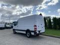 A 2017 Mercedes-Benz Sprinter van in white parked with its rear view facing the camera