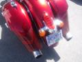 A shiny red 2017 Indian Chieftain Elite motorcycle showcasing its distinctive rear tail light and chrome exhaust pipes