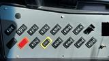 Control panel of a 2014 Freightliner Thomas Bus Diesel featuring various toggle switches and buttons in two rows