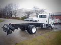 A 2006 International 4300 truck chassis with dual rear tires and an open cargo area showing the frame and suspension elements