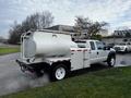 A white 2016 Ford F-550 truck with a large cylindrical tank mounted in the bed and equipment attached to the rear