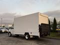 A white 2021 Ford Econoline with a boxy cargo area and a retractable rear ramp