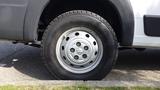 A close-up of a tire on a 2017 RAM Promaster showing a silver wheel with several holes and a black rubber tire with tread pattern