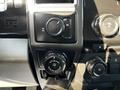 Dashboard controls of a 2017 Ford F-150 featuring a knob for trailer backup and various climate and audio controls