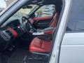 Interior of a 2020 Land Rover Range Rover Sport featuring red leather seats and a modern dashboard design