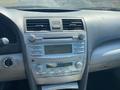 Dashboard of a 2007 Toyota Camry Hybrid featuring a radio display and control buttons for audio settings and climate control