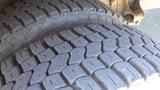 Close-up of two tires from a 2006 Ford Econoline showing detailed tread patterns and textures