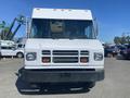 A front view of a white 2007 Freightliner MT55 delivery truck with large windows and a simple grille design