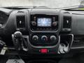 Dashboard of a 2018 RAM Promaster featuring a touchscreen display climate controls and gear shifter with various knobs and buttons