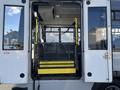 A 2018 Chevrolet Express with a yellow wheelchair lift at the rear entrance