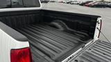 A 2016 Nissan Frontier pickup truck with a textured black bed liner in the truck bed