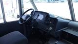 Interior view of a 2011 Ford Econoline showing the driver's seat steering wheel and dashboard controls