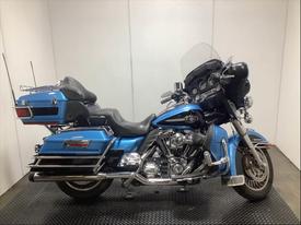 2011 Harley-Davidson Flhtcu in blue with black seating and chrome accents featuring a large windshield and saddlebags