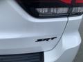 A white 2018 Jeep Grand Cherokee SRT showing the rear taillight and emblem on the back of the vehicle