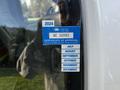 A 2015 Chevrolet Express with an inspection sticker showing a certificate of approval for British Columbia expiring in December 2024