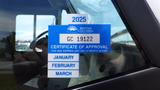 A blue certificate of approval sticker for a 2011 Ford Econoline displaying the year 2025 and the text Certificate of Approval with the months January February March listed