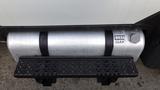 A silver diesel fuel tank mounted on a vehicle with a black step plate underneath and a labeled cap on the side