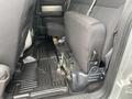 Interior view of the rear seats in a 2014 Ford F-150 showing gray fabric upholstery and floor mats