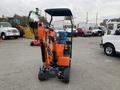 A 2024 AGT L12R mini excavator with an orange body and black attachments facing forward on a gravel surface