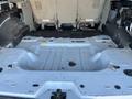 Interior view of a 2013 Ford Expedition showing the bare metal floor with no seats installed and some debris present