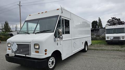 A 2006 Ford Econoline van with a white exterior and a flat front design featuring headlights and a large windshield