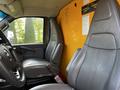 Interior view of a 2017 GMC Savana showing two gray leather seats and part of the dashboard