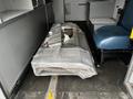 A 2016 Chevrolet Express cargo van with a wrapped metal item on the floor and a driver's seat visible in the front cabin