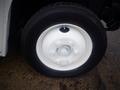 Close-up of a white wheel on a 2003 Freightliner MT45 Chassis with a six-bolt pattern and a central hub hole