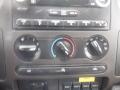 Control panel of a 2009 Ford F-450 SD featuring knobs for air conditioning and other systems with various buttons below