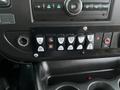 Dashboard controls of a 2017 Chevrolet Express with buttons for lights and doors