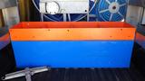 A large storage box painted orange and blue with multiple compartments designed for organizing equipment or supplies