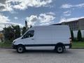 A white 2017 Mercedes-Benz Sprinter van viewed from the side showcasing its sleek design and large cargo space