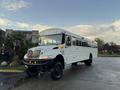 A 2015 International 3000 school bus painted white with large windows and an elevated front hood