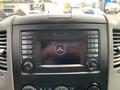 Dashboard display of a 2017 Mercedes-Benz Sprinter featuring the Mercedes-Benz logo and control buttons for radio and media functions