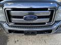 Front view of a 2013 Ford F-450 Super Duty with a shiny chrome grille and prominent Ford logo