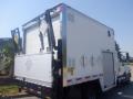 A 2014 International TerraStar truck with a white cargo box featuring diamond-shaped vents and a side roll-up door