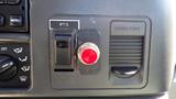 Control panel of a 2006 Ford F-650 featuring a red button labeled PTO and a power point outlet