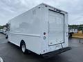 A white 2005 Freightliner MT45 Chassis with a flat rear cargo area and a roll-up door